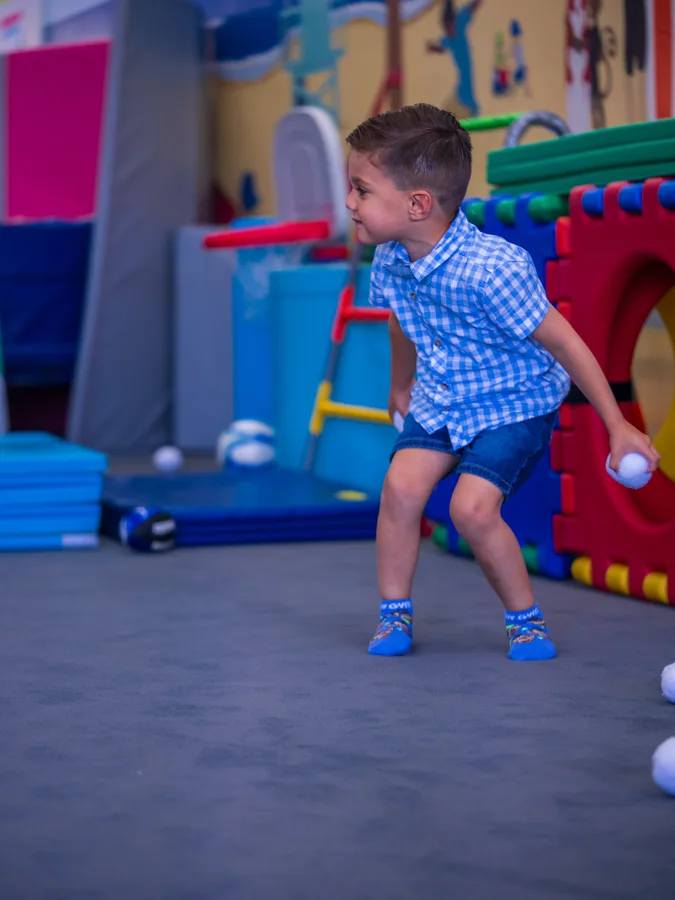 Child running through a colourful indoor activity space