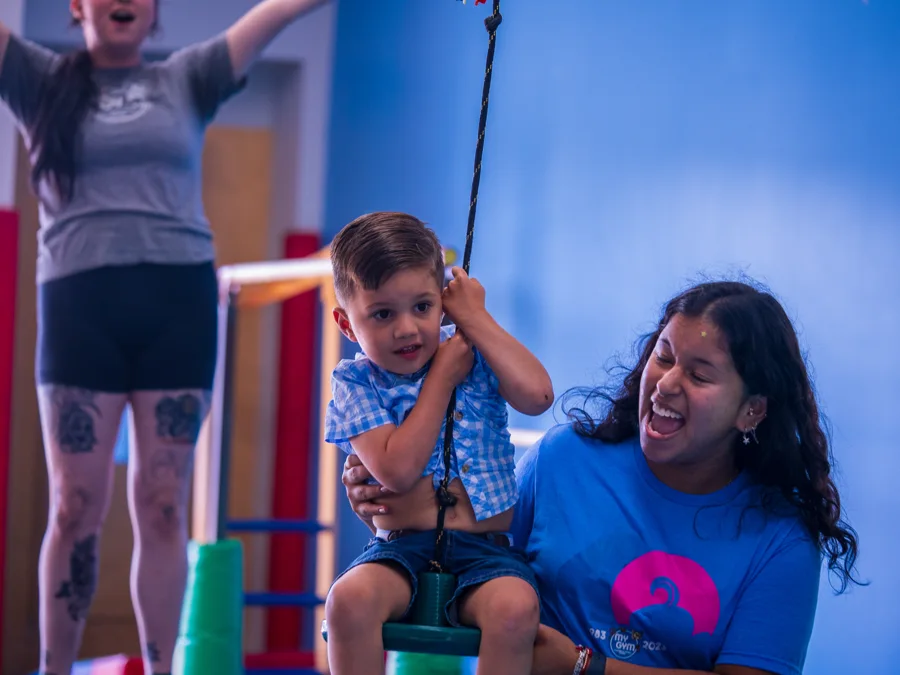 Candid moment between a child and an adult at an indoor event