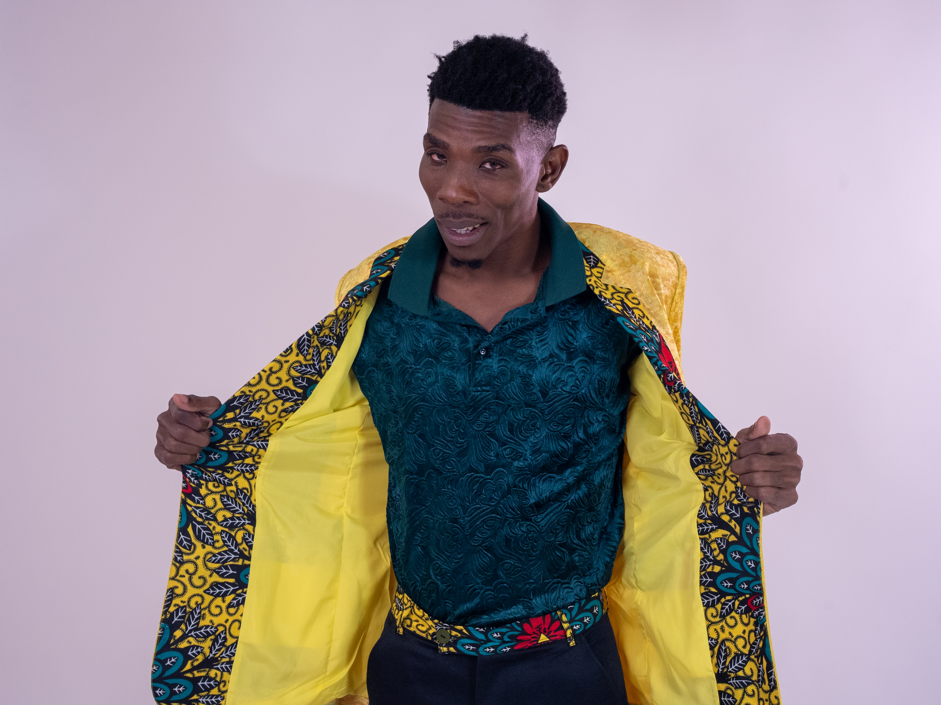 Portrait showing the green shirt and patterned yellow jacket lining