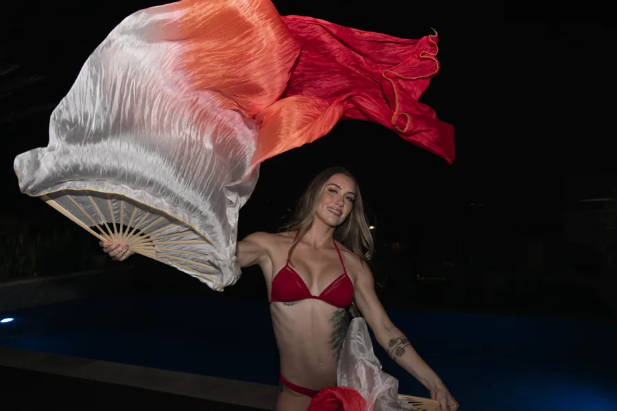 Fashion portrait with flowing red and white fabric