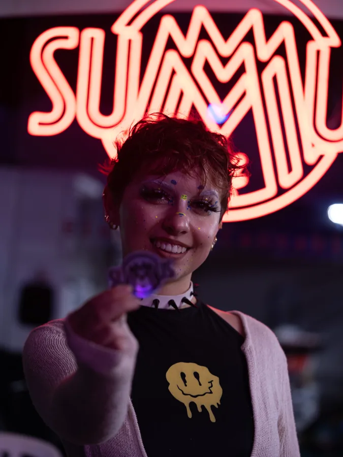 Portrait in front of a glowing neon sign